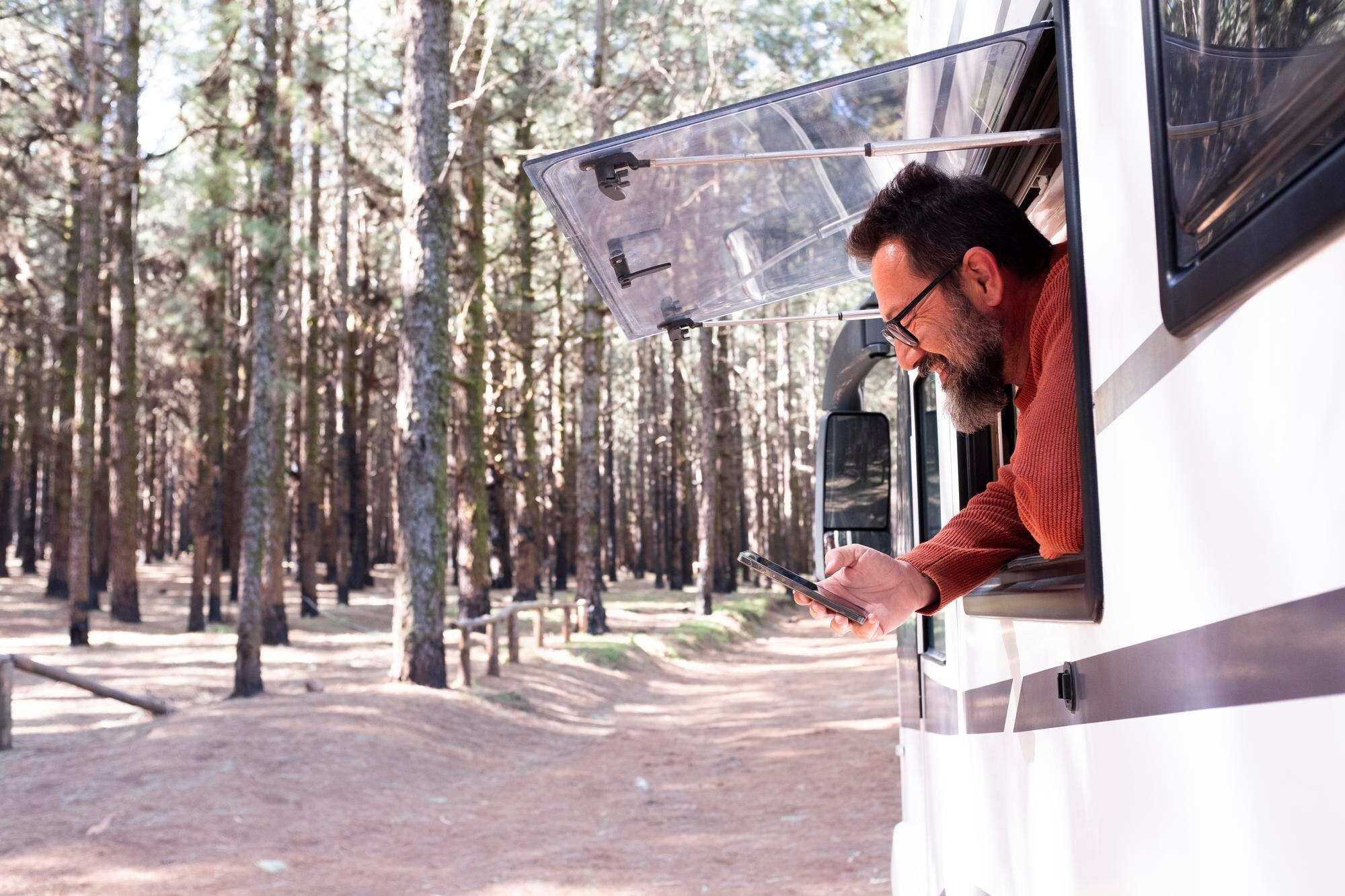 advanturecamperizaciones.orbidi.tech Website - Contacto - one man enjoying view outside window motorhome camper van enjoying vanlife alternative travel vehicl